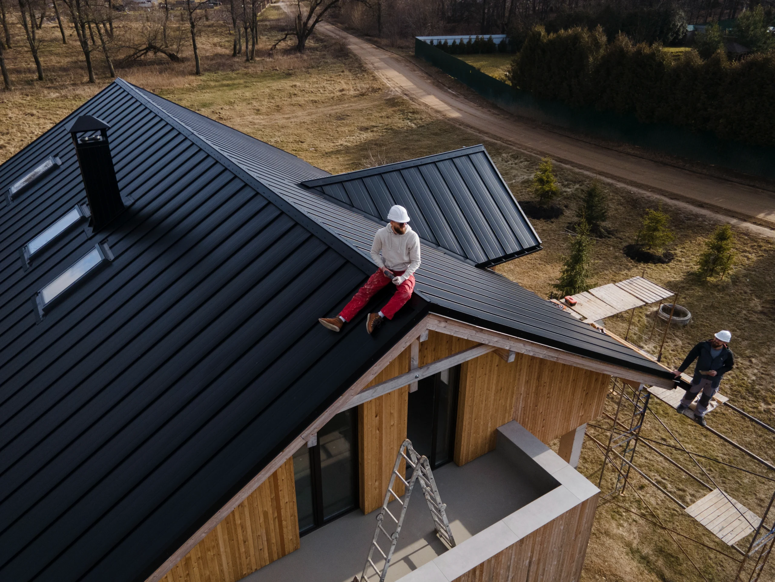 long-shot-man-with-helmet-sitting-roof